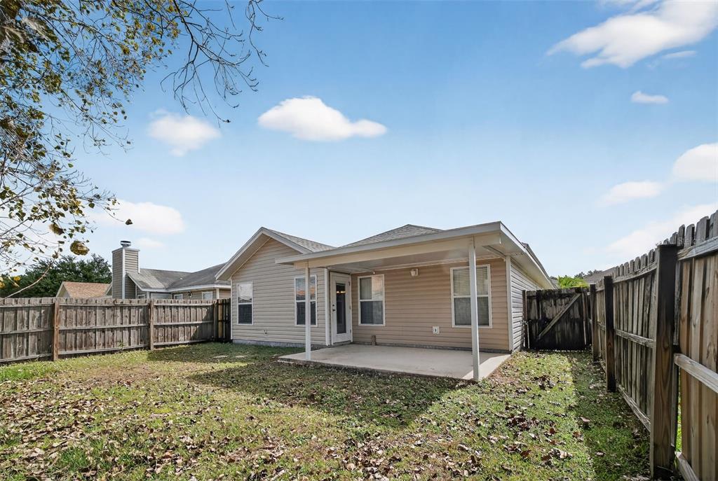 96025 Sunfish Lane Yulee, FL 32097 - Photo 16 of 17 a view of a house with a big yard and a garden