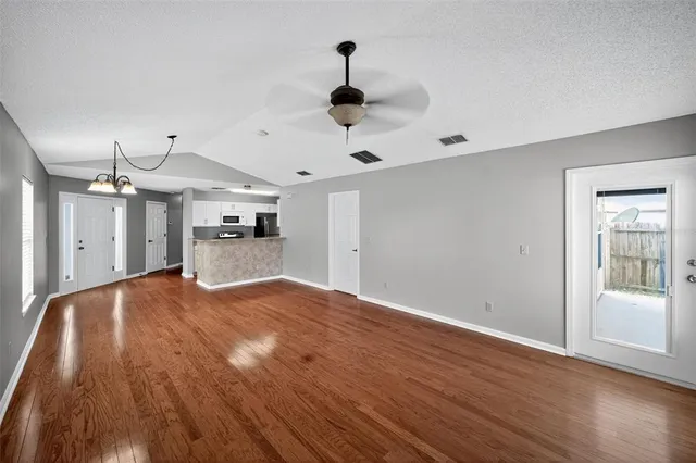 a kitchen with granite countertop a stove and a wooden floors