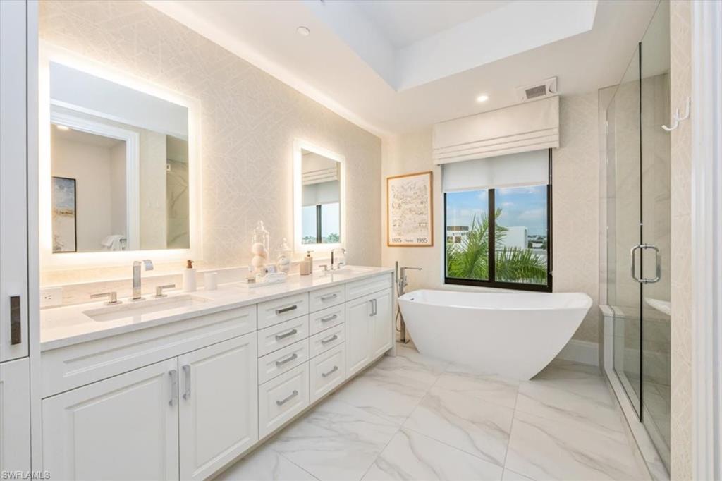 1130 3rd Avenue South, Unit 416 Naples, FL 34102 - Photo 21 of 49 a bathroom with a granite countertop sink mirror and bathtub