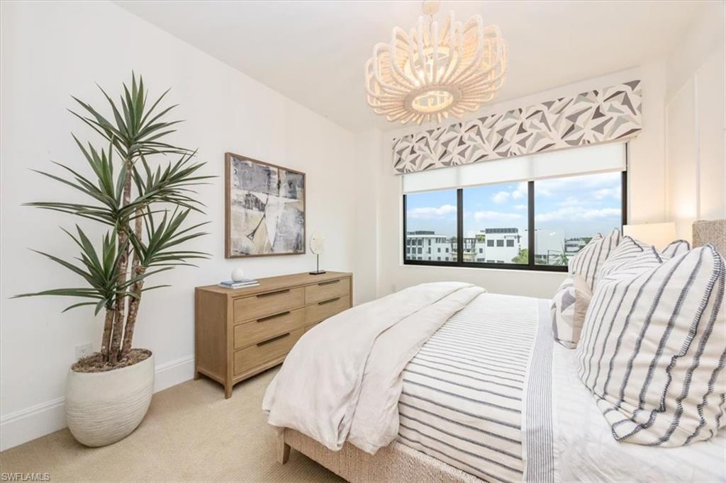 1130 3rd Avenue South, Unit 416 Naples, FL 34102 - Photo 30 of 49 a bedroom with a large bed and a large window