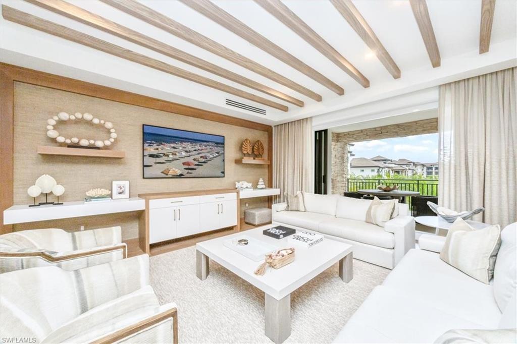 1130 3rd Avenue South, Unit 416 Naples, FL 34102 - Photo 4 of 49 a living room with furniture and a large window