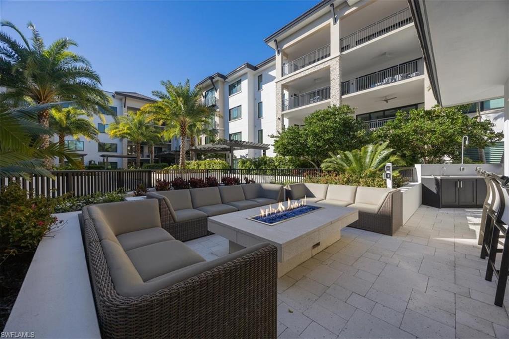 1130 3rd Avenue South, Unit 416 Naples, FL 34102 - Photo 41 of 49 a view of a patio with couches and potted plants