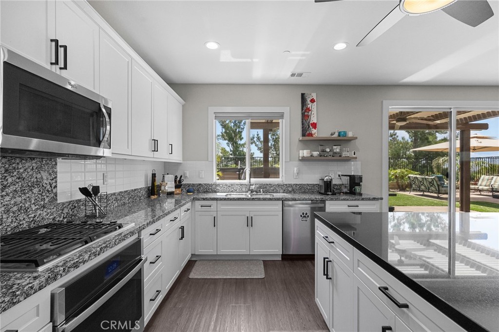 19512 Griffith Drive Saugus, CA 91350 - Photo 12 of 46 a kitchen with a sink stove top oven and cabinets