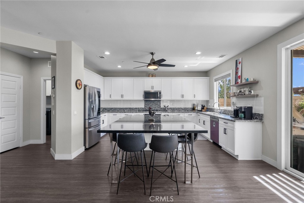 19512 Griffith Drive Saugus, CA 91350 - Photo 8 of 46 a kitchen with stainless steel appliances a dining table chairs and wooden floor