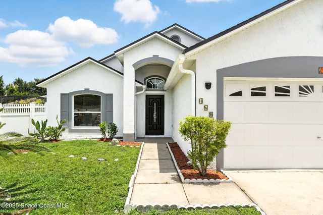 a front view of a house with garden