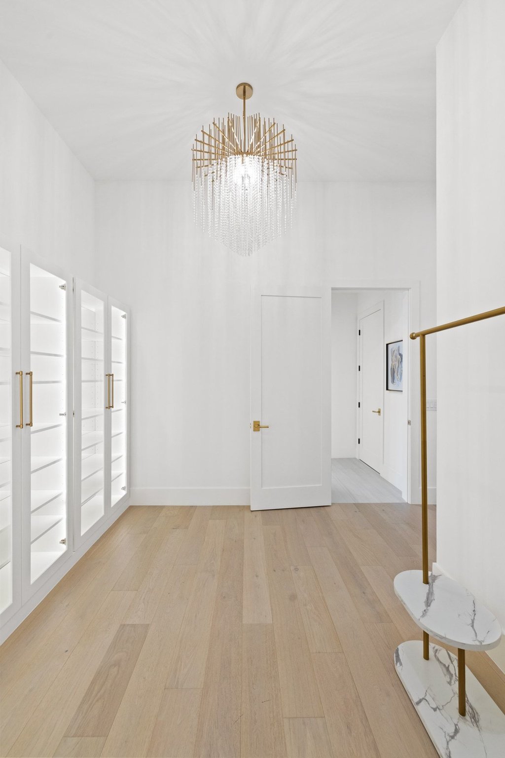 7117 Davenport Divide Road Austin, TX 78738 - Photo 26 of 40 A refined walk-in closet with illuminated built-ins and natural wood flooring.