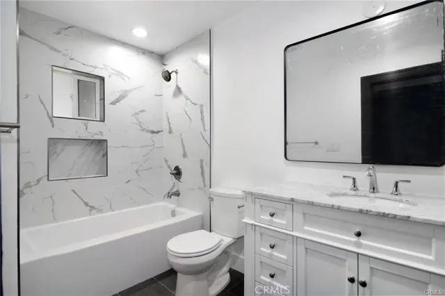 a bathroom with a sink a toilet and bathtub