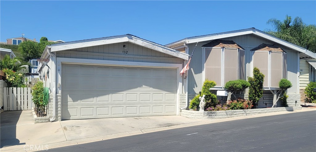 a view of a house with a yard and garage