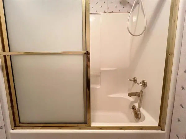 a bathroom with a glass shower door