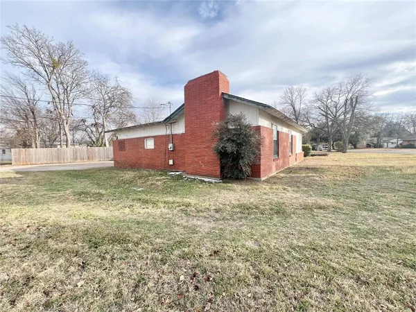 a front view of house with yard and trees