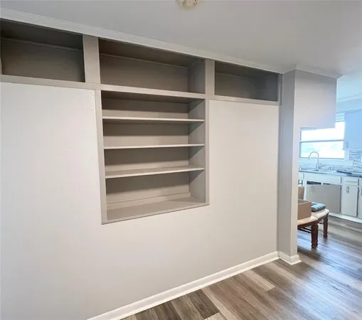 a view of a room with wooden floor and a window