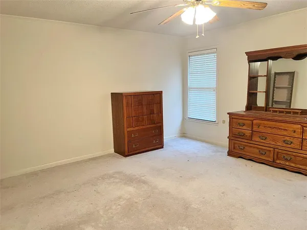 an empty room with furniture and natural light