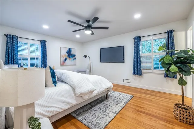 a bedroom with a large bed and a chandelier