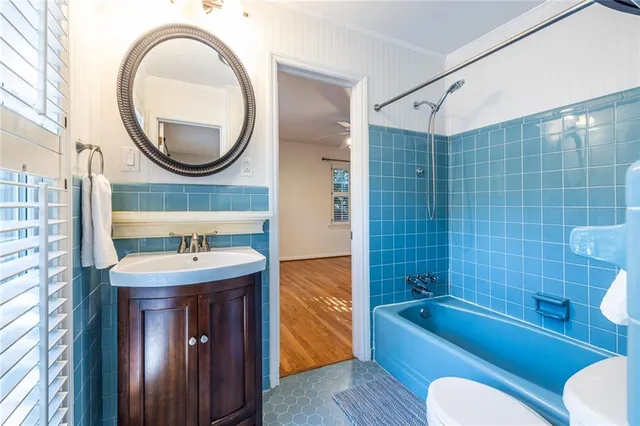 a bathroom with a sink a bathtub and a mirror