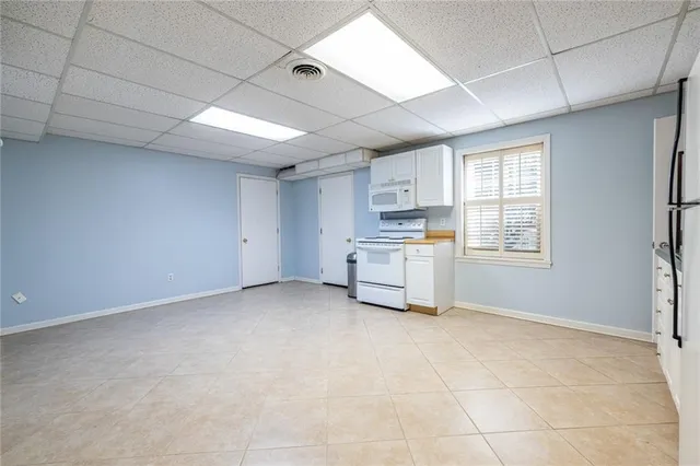 a view of kitchen with sink and cabinets