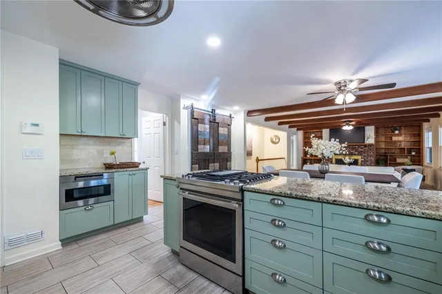 a kitchen with granite countertop a stove and a sink