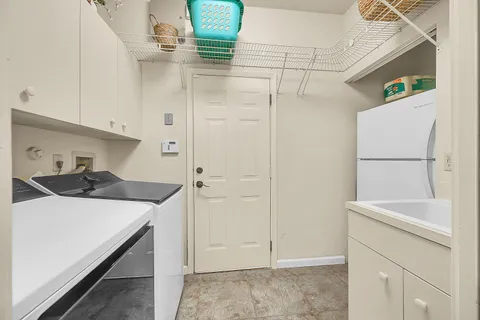 a kitchen with a sink a refrigerator and cabinets