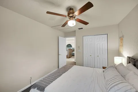 a bedroom with a large bed and a chandelier