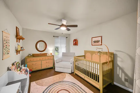 a bedroom with furniture and a large window
