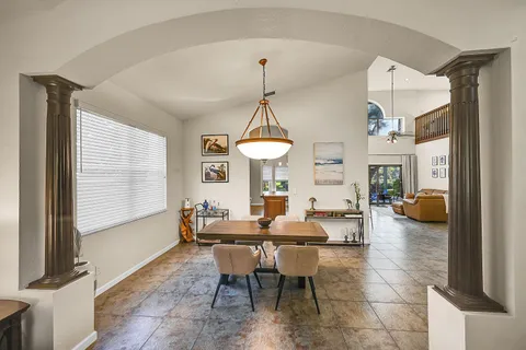 a dining room with furniture and a chandelier