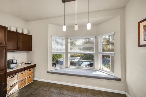 a open kitchen with granite countertop a stove and a sink with dishwasher