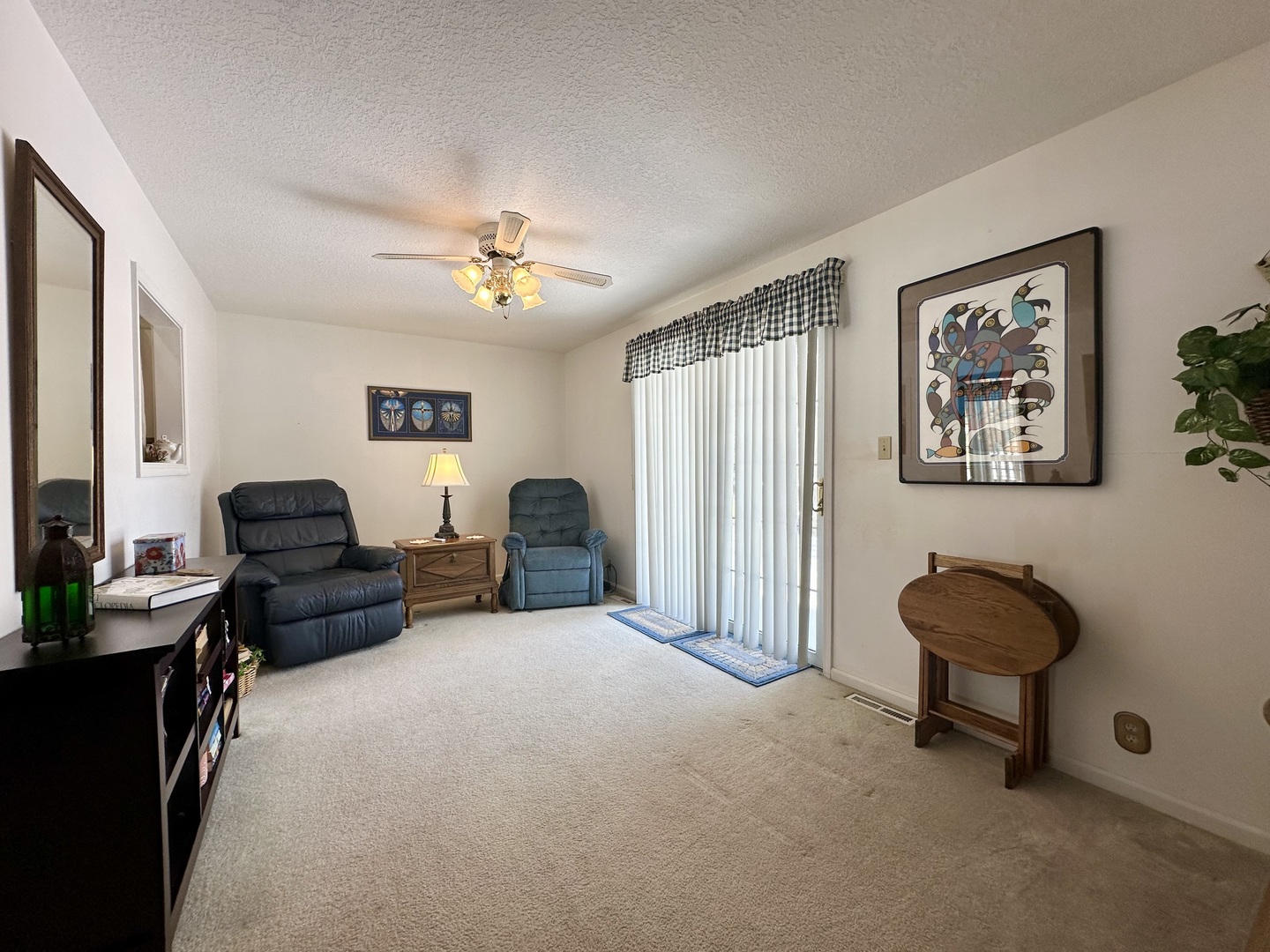 8752 Wagon Trail Road Clinton, IL 61727 - Photo 12 of 19 a living room with furniture and a lamp