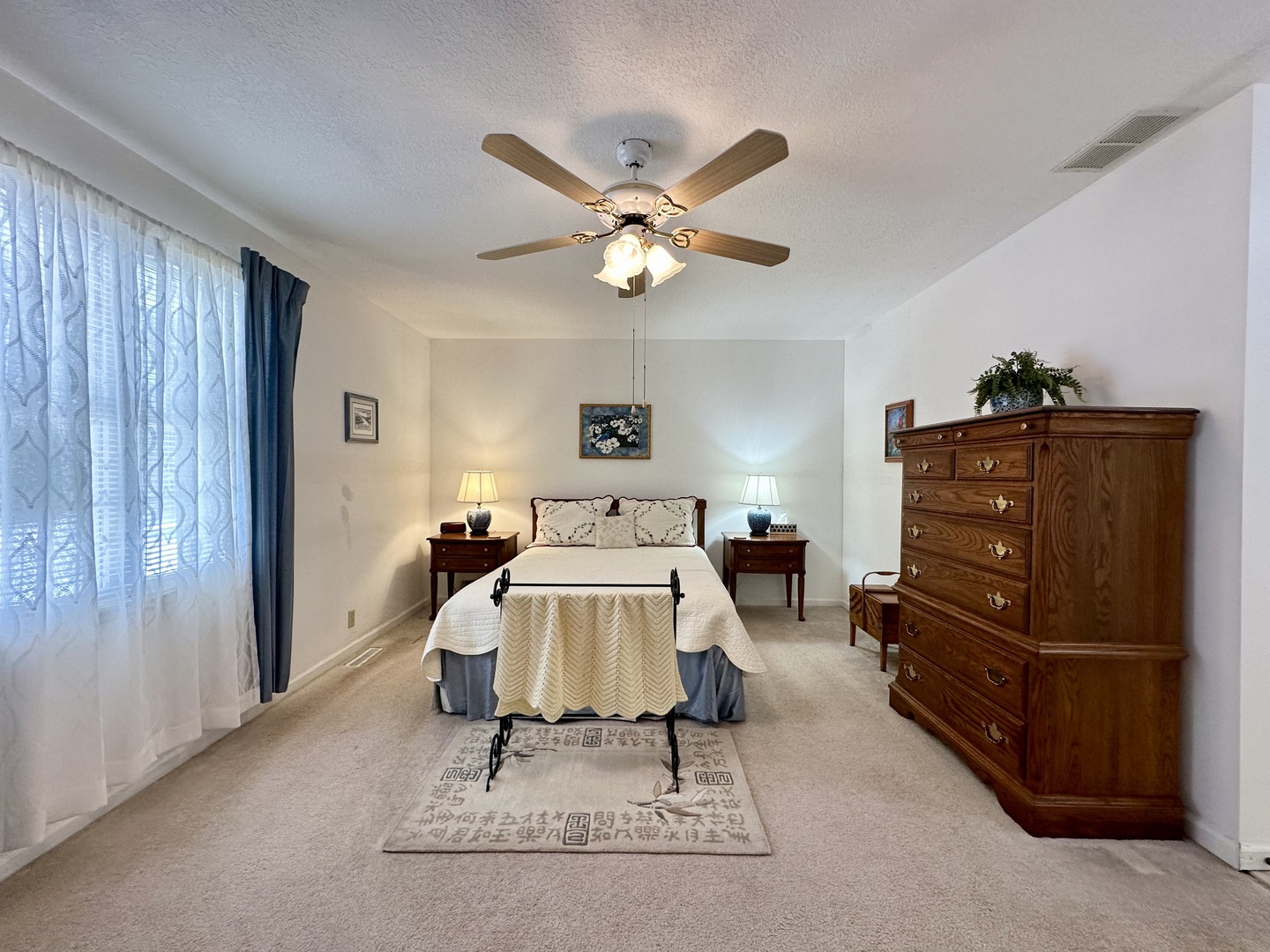 8752 Wagon Trail Road Clinton, IL 61727 - Photo 13 of 19 a bed room with a bed and a ceiling fan