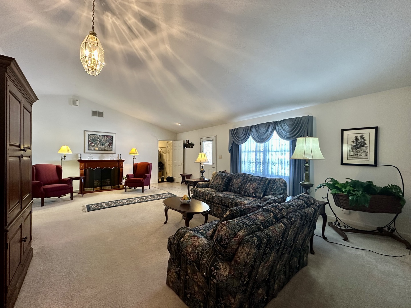 8752 Wagon Trail Road Clinton, IL 61727 - Photo 2 of 19 a living room with furniture and a chandelier