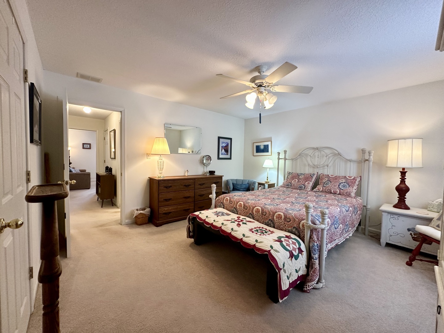 8752 Wagon Trail Road Clinton, IL 61727 - Photo 7 of 19 a spacious bedroom with a bed and a chandelier