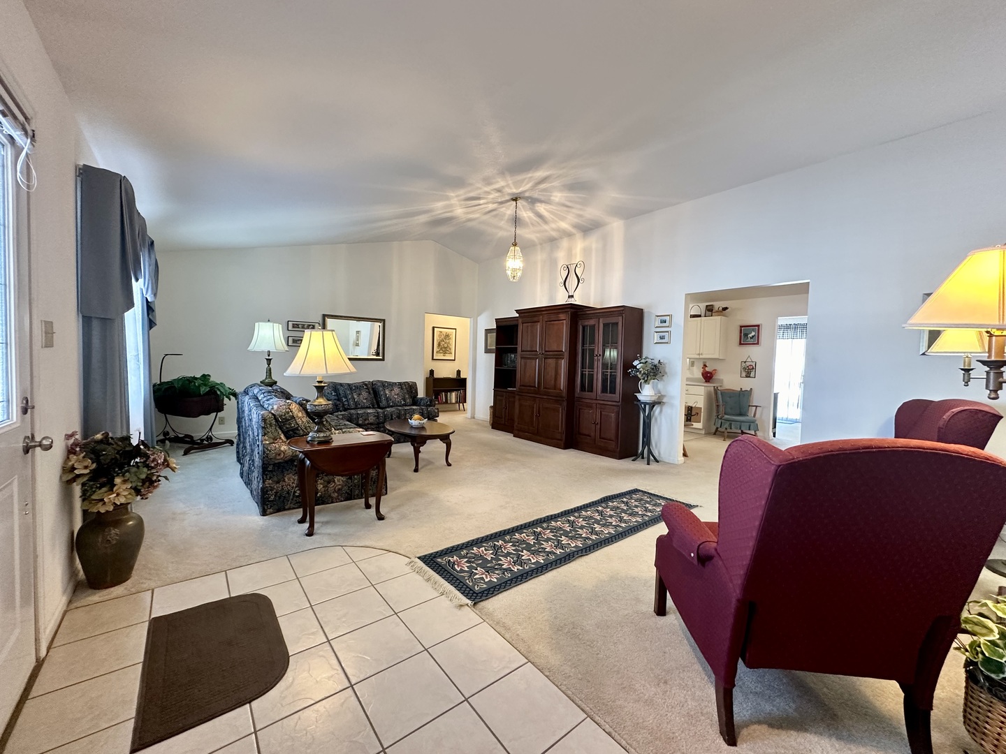 8752 Wagon Trail Road Clinton, IL 61727 - Photo 9 of 19 a living room with furniture a chandelier and a dining table with wooden floor