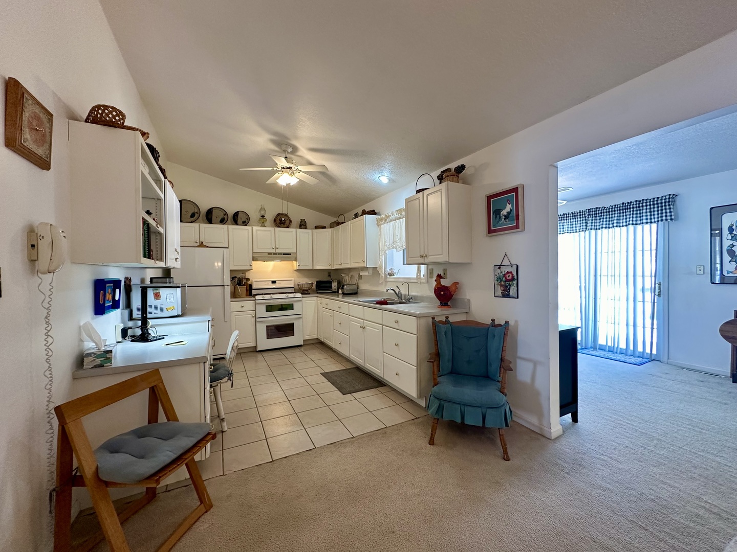 8752 Wagon Trail Road Clinton, IL 61727 - Photo 10 of 19 a kitchen with a refrigerator and white cabinets