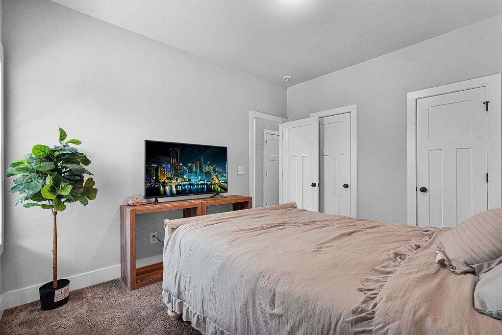 1201 Shiva Boulevard Winder, GA 30680 - Photo 13 of 84 a bedroom with a bed and a flat screen tv