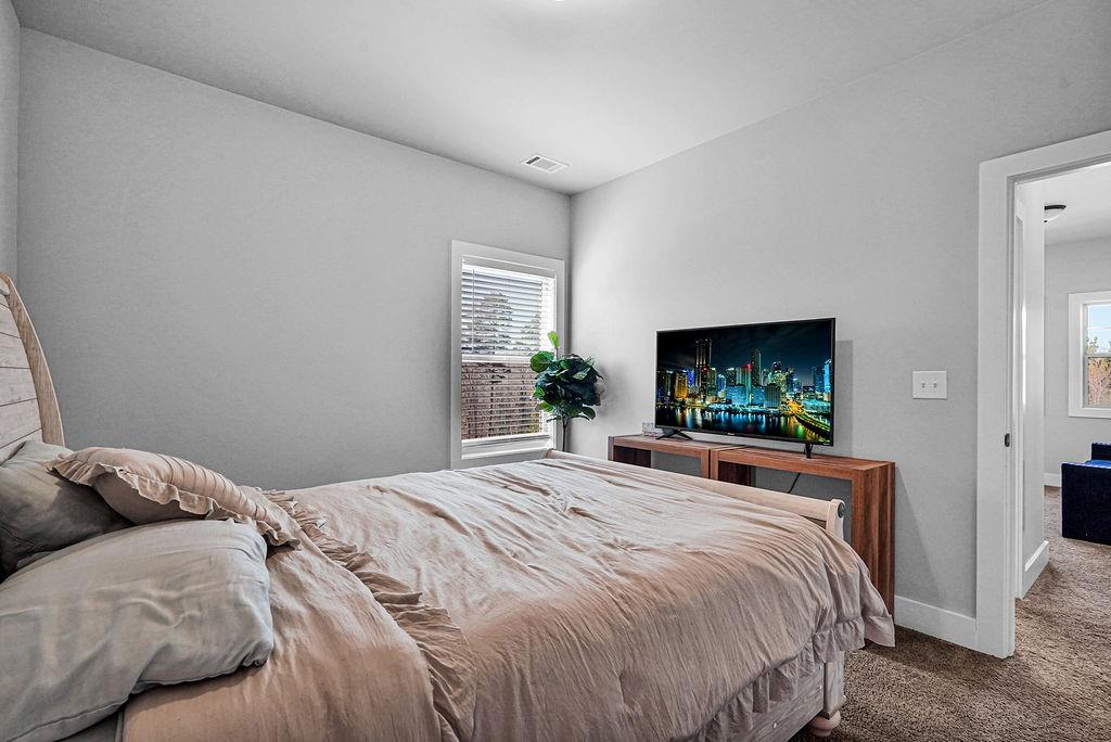 1201 Shiva Boulevard Winder, GA 30680 - Photo 14 of 84 a bedroom with a bed and a flat screen tv