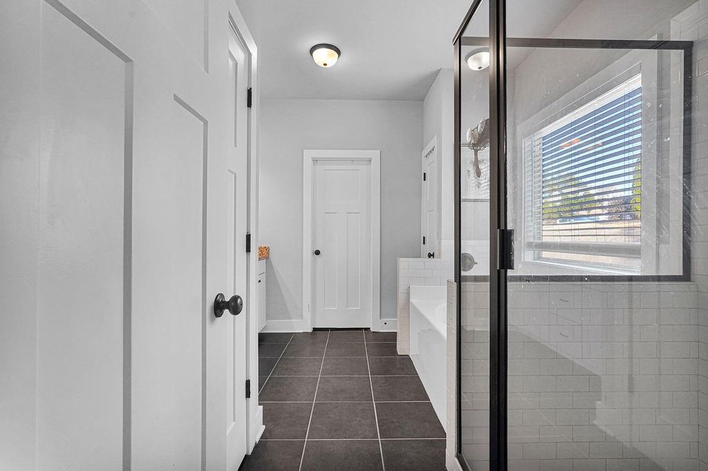 1201 Shiva Boulevard Winder, GA 30680 - Photo 24 of 84 a bathroom with a glass door shower a sink and a shower