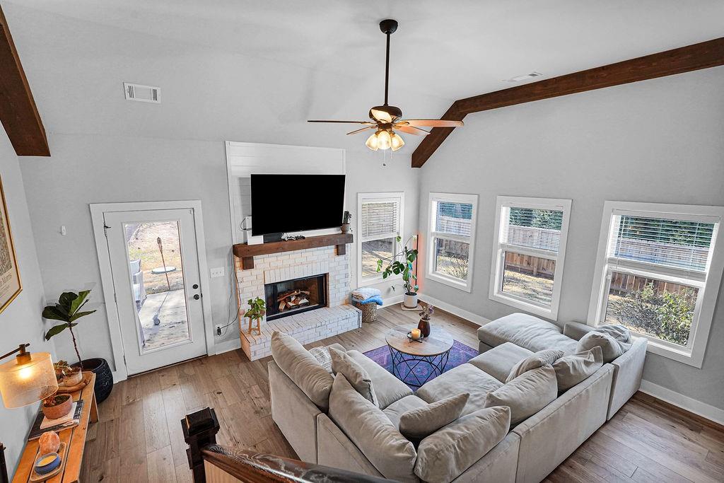 1201 Shiva Boulevard Winder, GA 30680 - Photo 31 of 84 a living room with furniture a fireplace and a flat screen tv