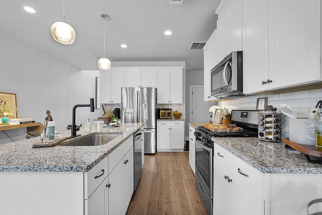 1201 Shiva Boulevard Winder, GA 30680 - Photo 32 of 84 a kitchen with stainless steel appliances granite countertop a sink stove and cabinets