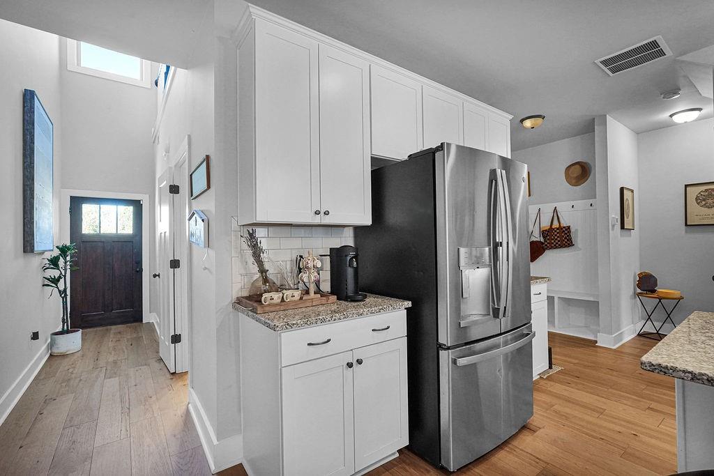 1201 Shiva Boulevard Winder, GA 30680 - Photo 40 of 84 a kitchen with stainless steel appliances a refrigerator stove and wooden floor