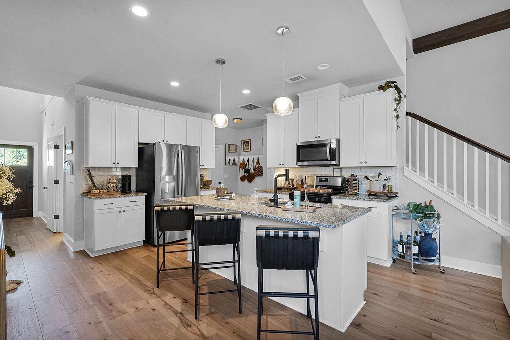 1201 Shiva Boulevard Winder, GA 30680 - Photo 43 of 84 a kitchen with stainless steel appliances a refrigerator and a stove top oven