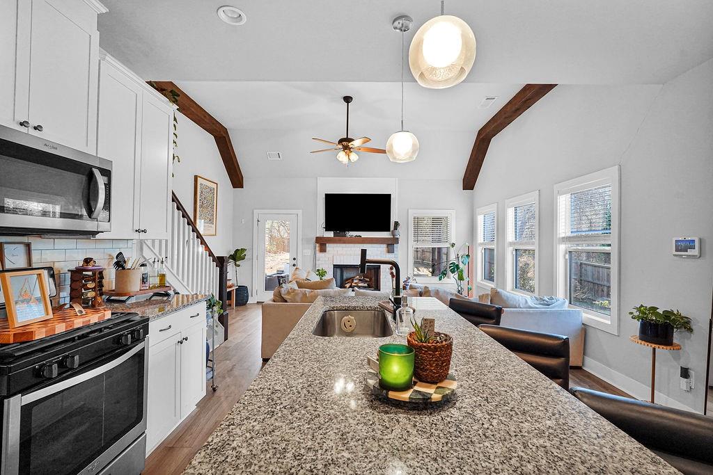 1201 Shiva Boulevard Winder, GA 30680 - Photo 46 of 84 a living room with furniture a flat screen tv and kitchen view