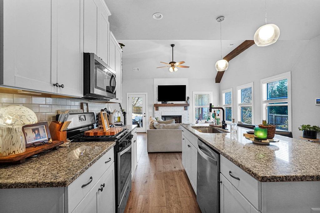1201 Shiva Boulevard Winder, GA 30680 - Photo 47 of 84 a kitchen with stainless steel appliances granite countertop a sink stove and cabinets