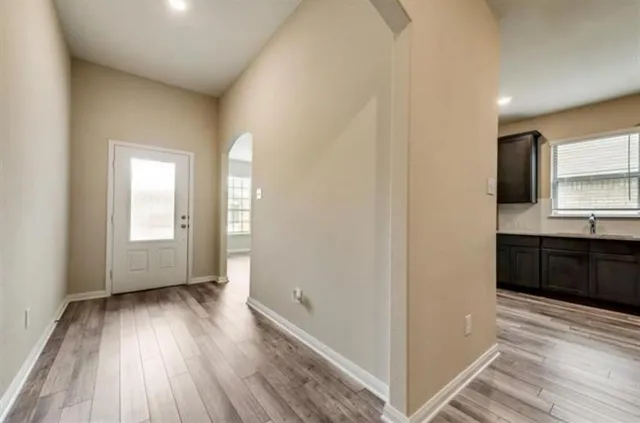 a view of a kitchen cabinets wooden floor and a window