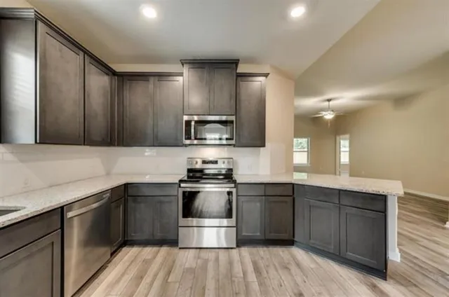 a kitchen with a sink stove and cabinets