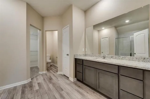 a bathroom with a double vanity sink and mirror