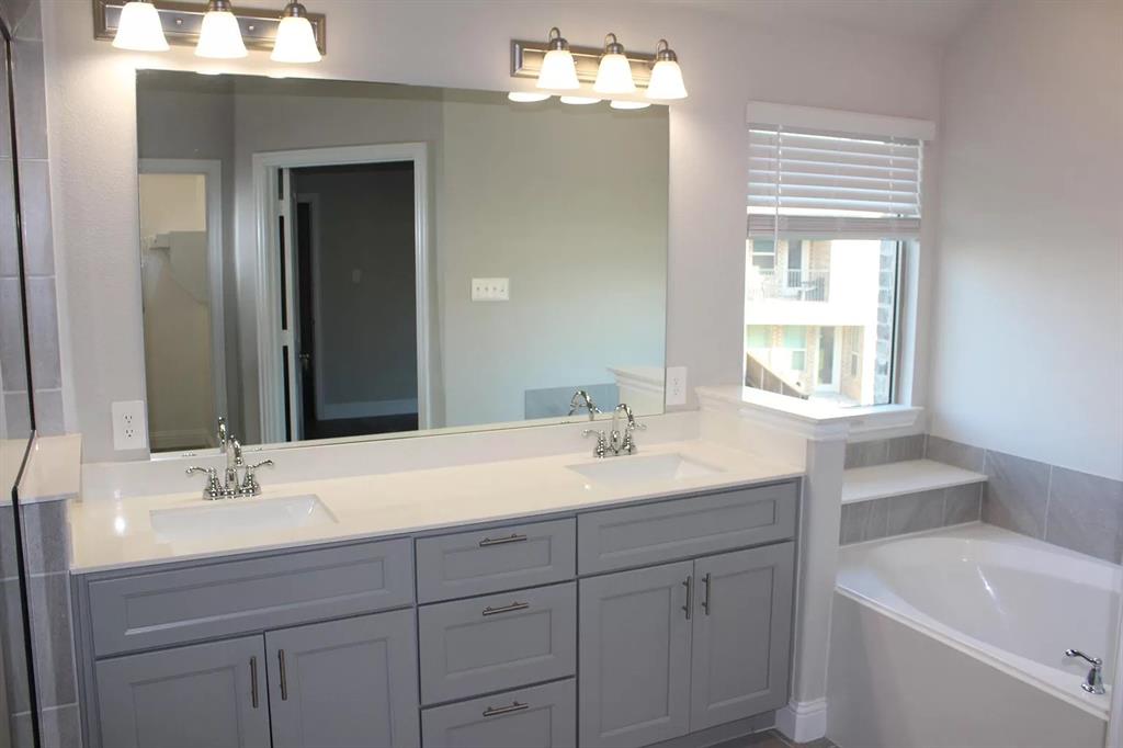 1752 Redding Street Allen, TX 75002 - Photo 14 of 24 Bathroom with a washtub and dual bowl vanity