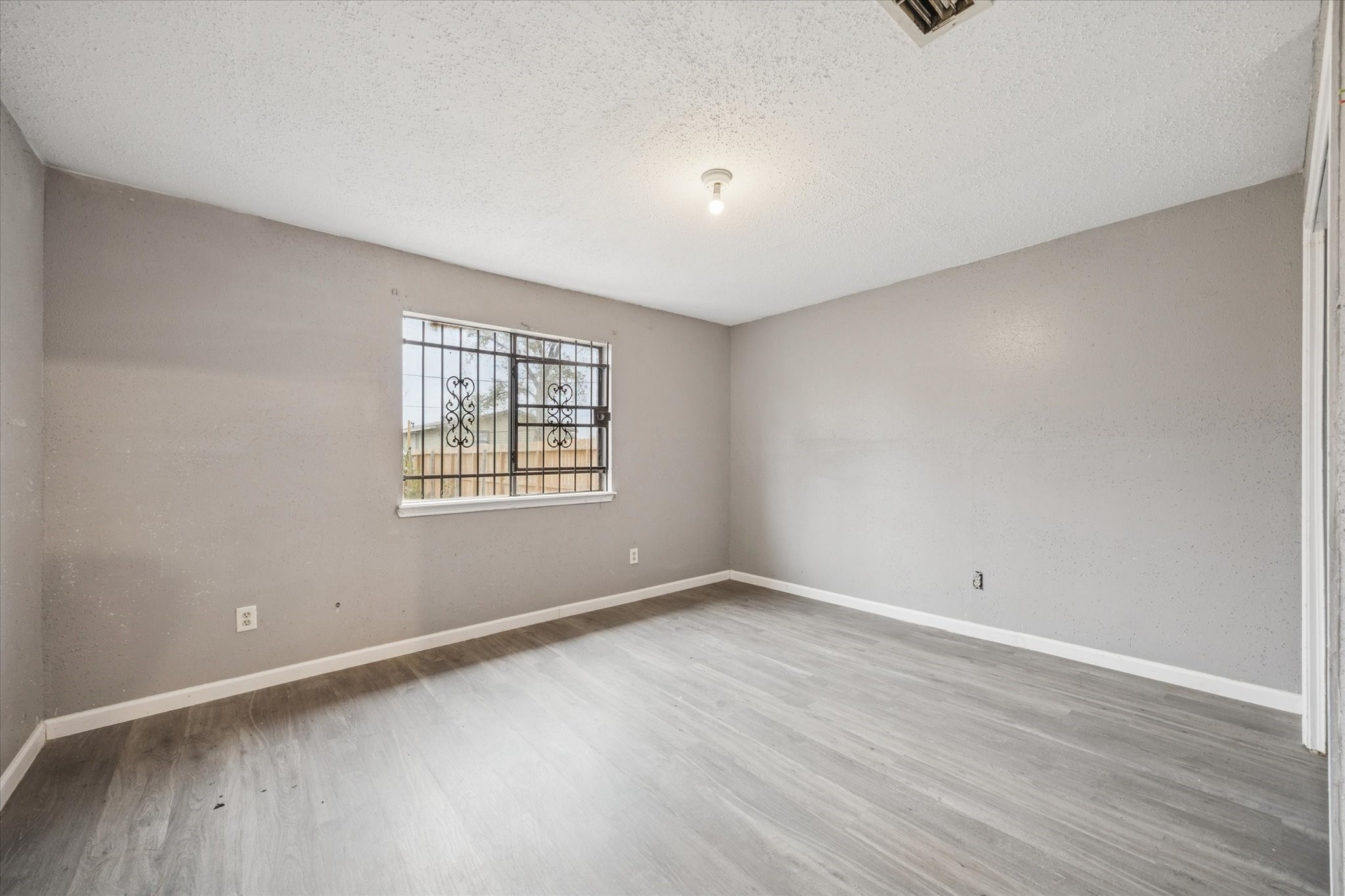9910 Genard Road Houston, TX 77041 - Photo 12 of 15 wooden floor in an empty room with a window