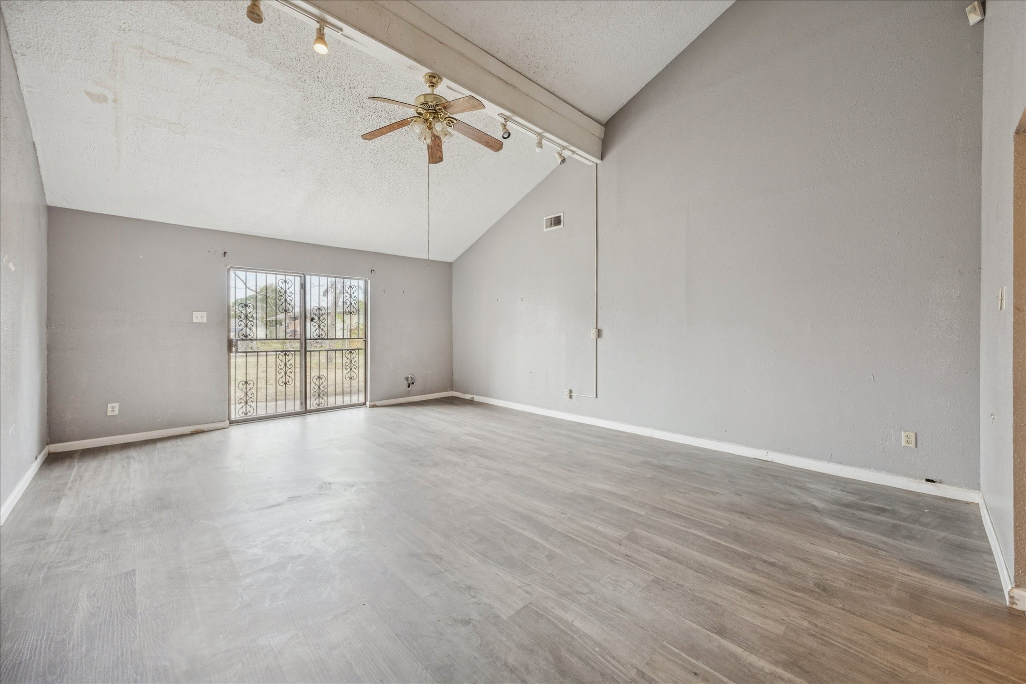 9910 Genard Road Houston, TX 77041 - Photo 3 of 15 an empty room with wooden floor and windows