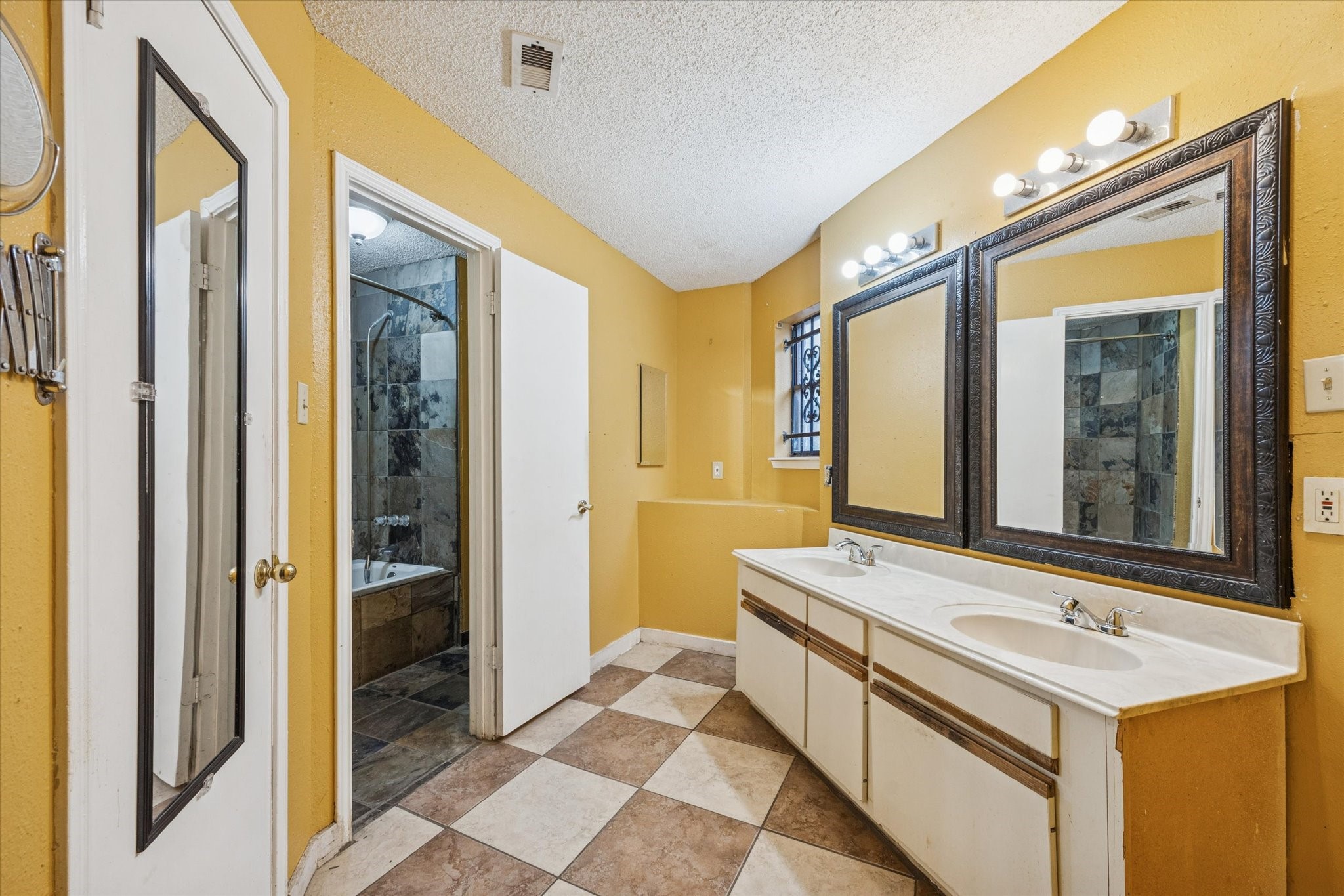 9910 Genard Road Houston, TX 77041 - Photo 9 of 15 a bathroom with a sink a mirror and a shower