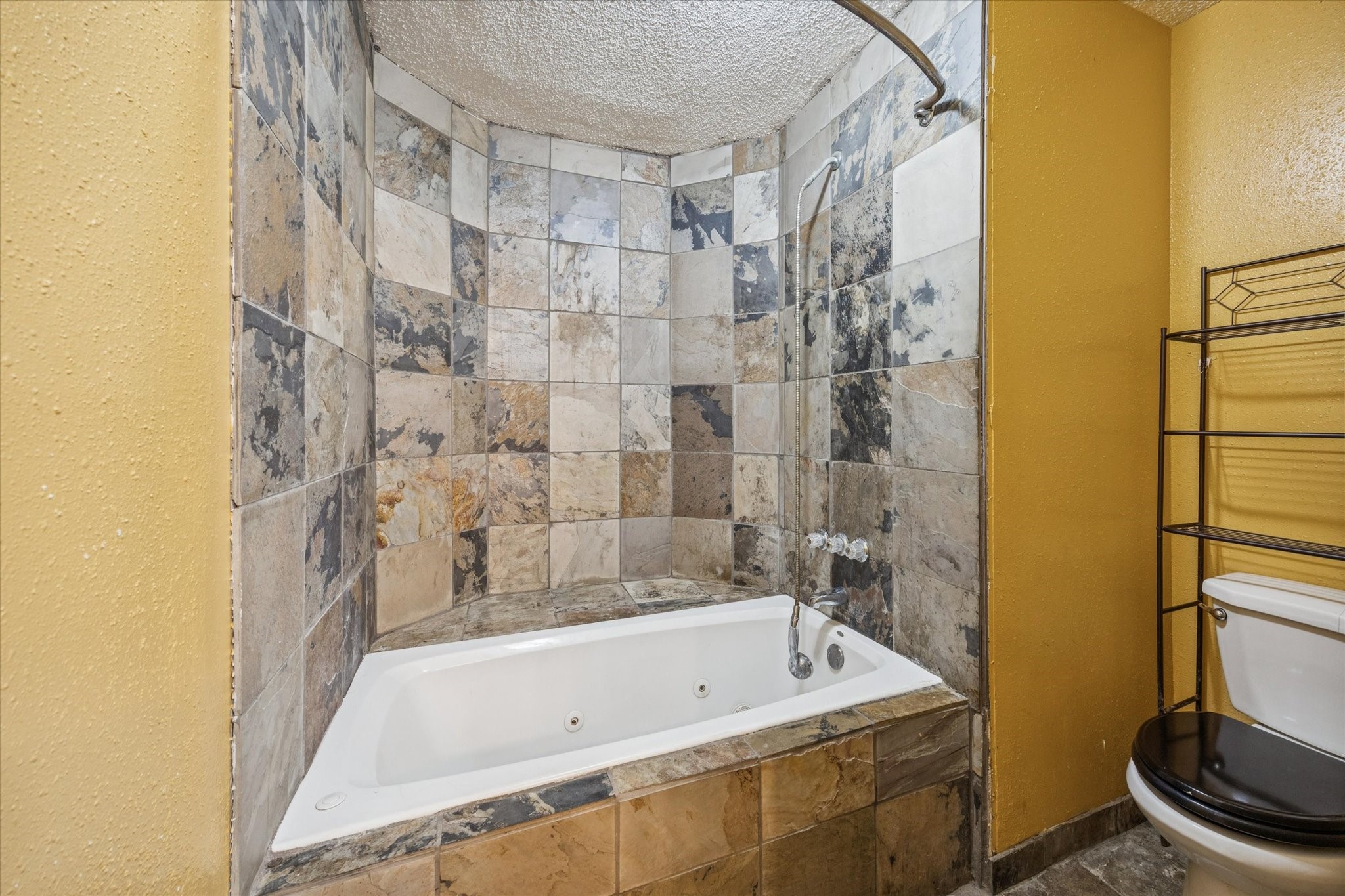 9910 Genard Road Houston, TX 77041 - Photo 10 of 15 a bathroom with a tub and a shower