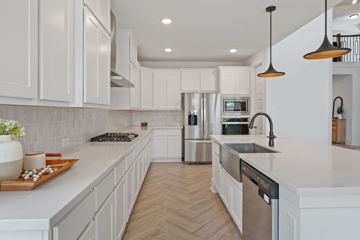 914 Sendero Trail Conroe, TX 77304 - Photo 12 of 50 a kitchen with stainless steel appliances granite countertop a sink a stove and a refrigerator