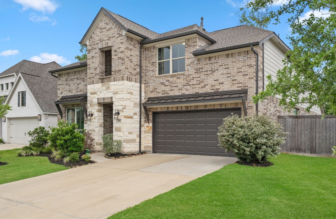 914 Sendero Trail Conroe, TX 77304 - Photo 2 of 50 a front view of a house with a garden